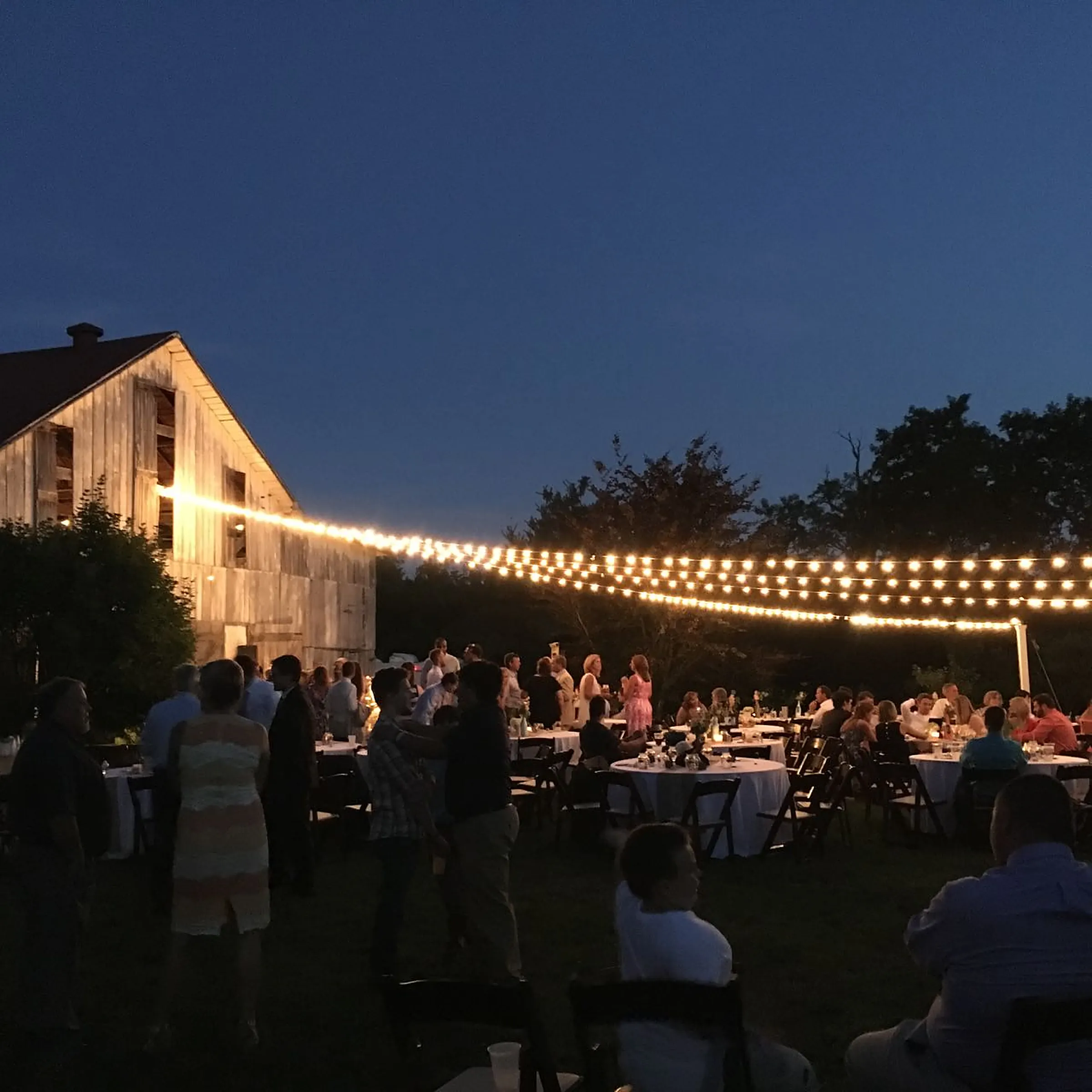 An evening wedding reception glowing with candlelight