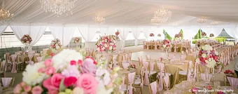 Reception dining tables dressed in blush linens